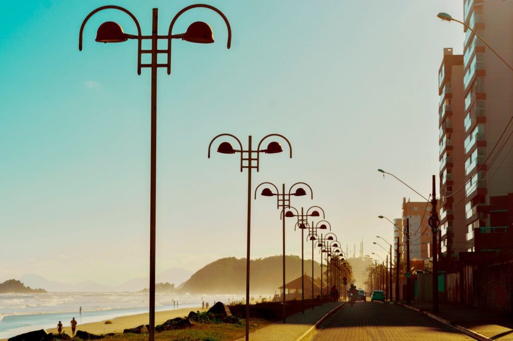 Municipal solar street lights with solar panels mounted on top in a public parking area.