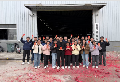 Sunlux Lighting team celebrating the Lunar New Year kickoff at the factory entrance.