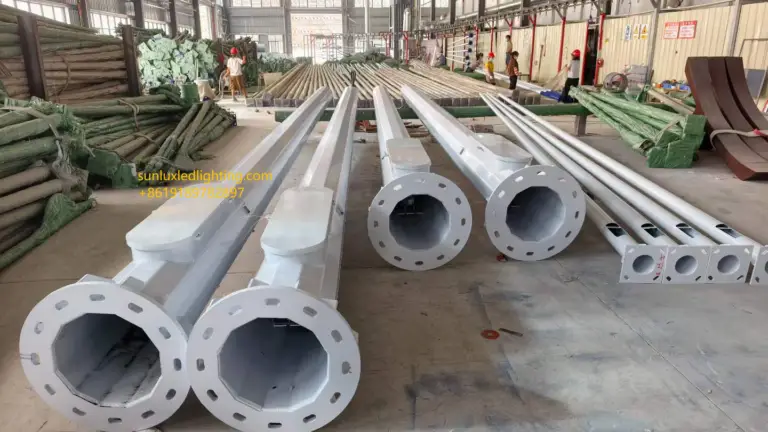 Smart pole bodies with protective surface finishes, base flanges, and access openings arranged inside a manufacturing workshop.