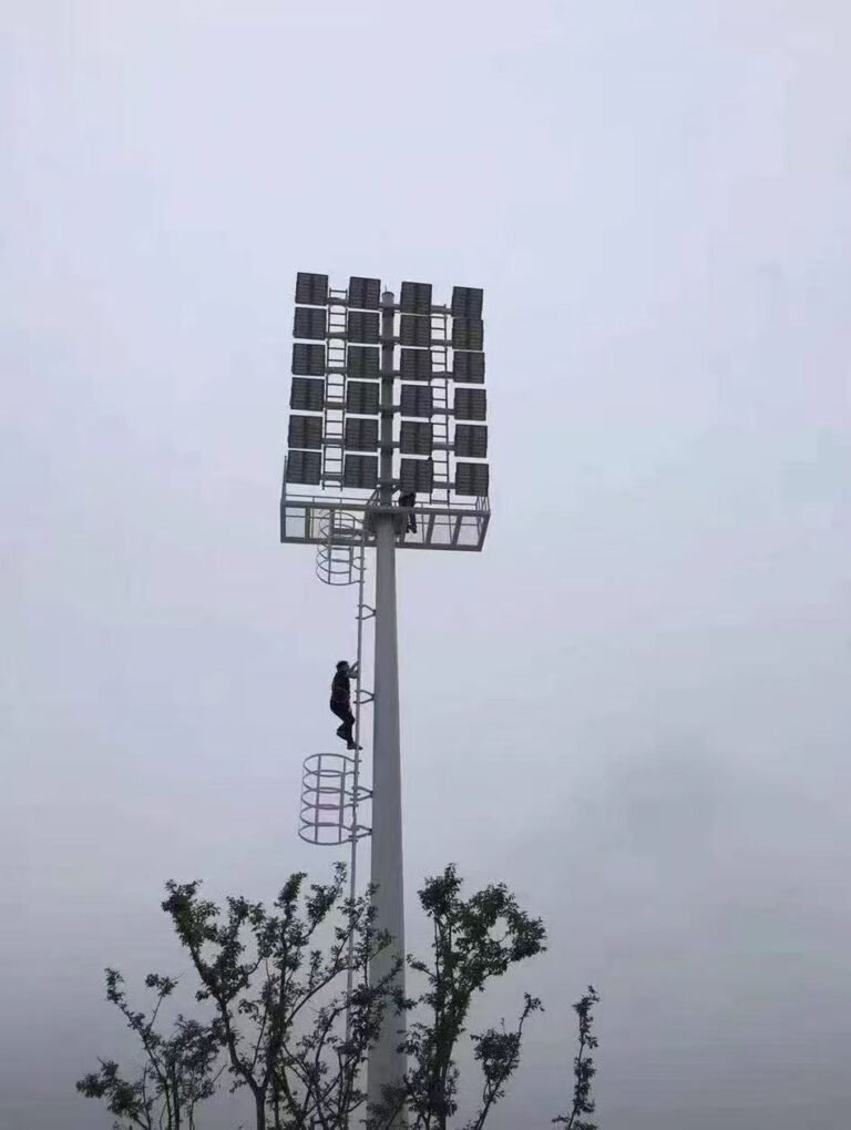 High mast lighting pole with maintenance ladder platform and floodlight array
