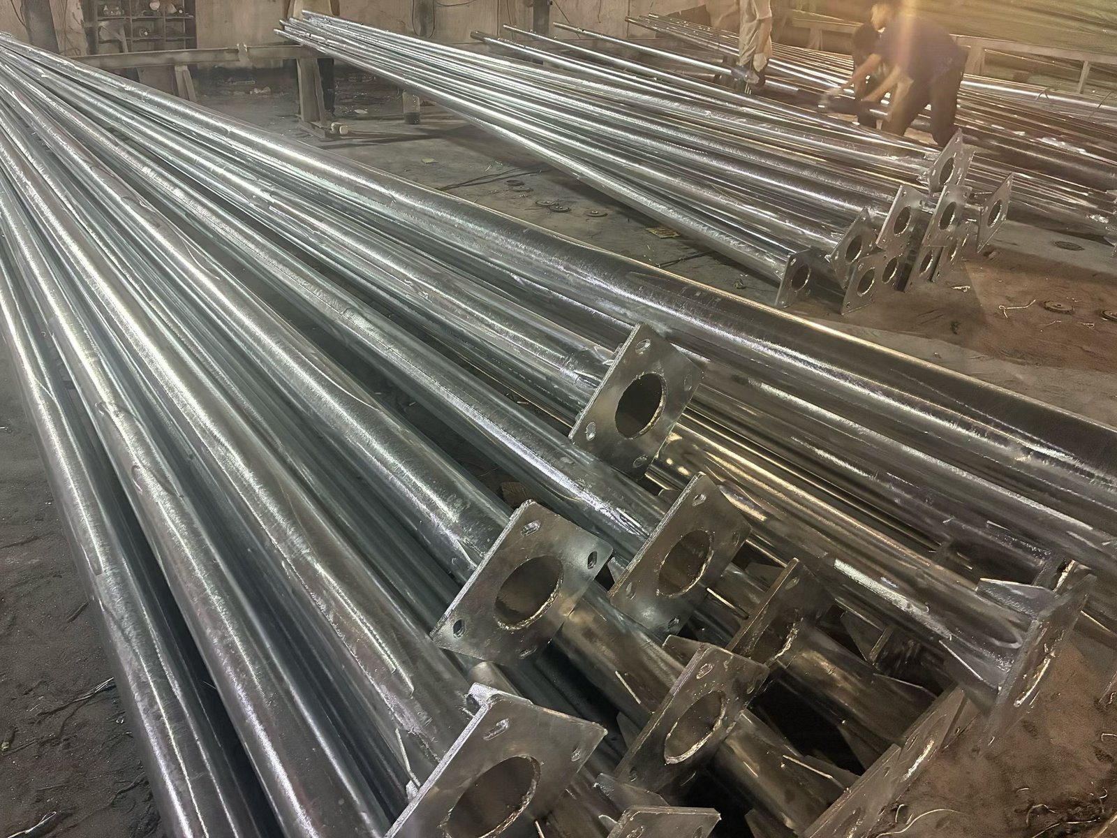 Fabricated steel lighting poles with welded base plates
